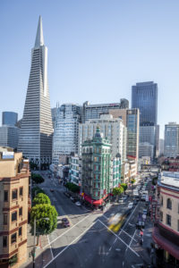 large intersection surrounded by skyscrapers large intersection surrounded by skyscrapers